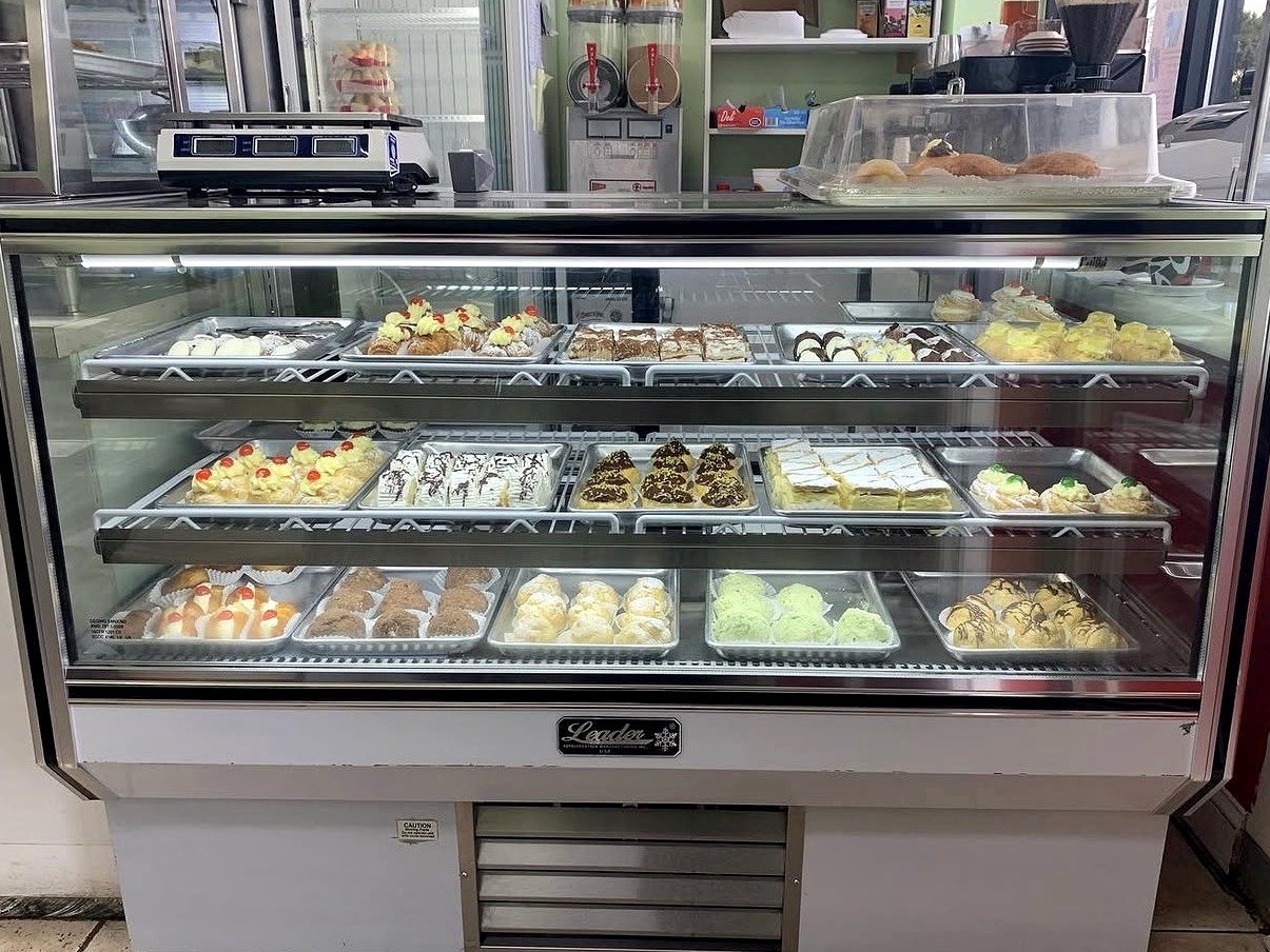 Full pastry display case at Four Seasons Ice Cream showing three shelves of Italian desserts