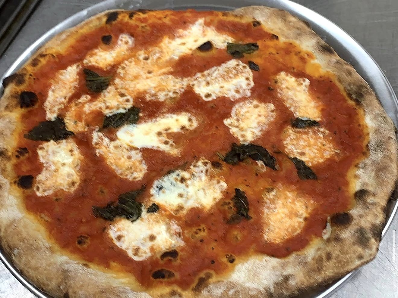 Fresh homemade margherita pizza with basil and mozzarella at Four Seasons Ice Cream
